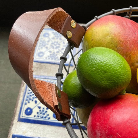 woven iron metal round fruit basket with cognac brown leather handles