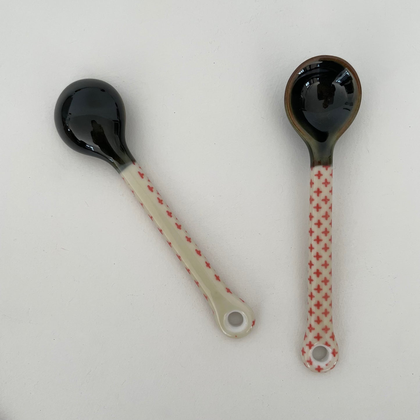 handmade small Japanese pottery spoon for coffee or tea in red and cream cross pattern