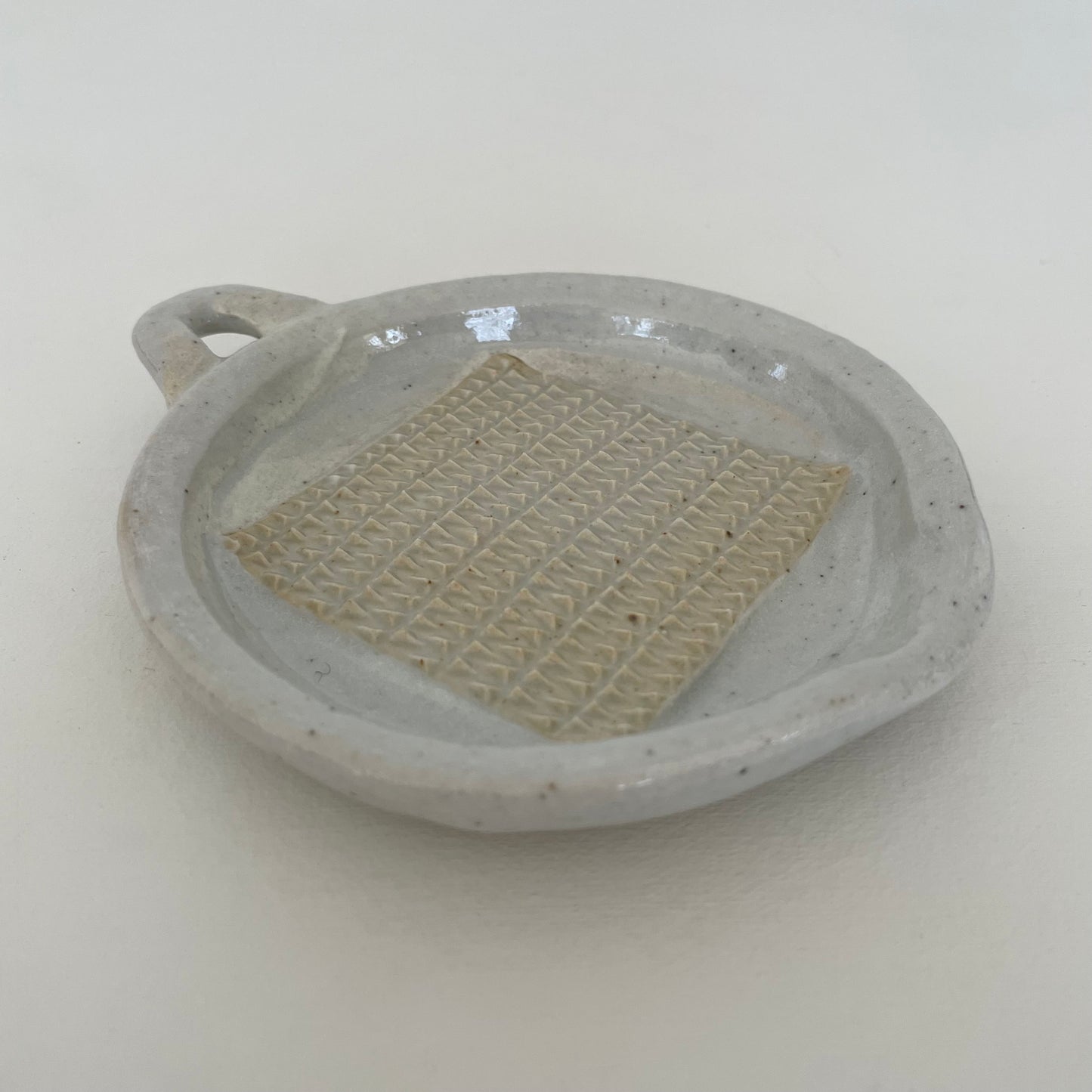 neutral grey and cream gohonte handmade ceramic pottery Japanese small round food grater with handle