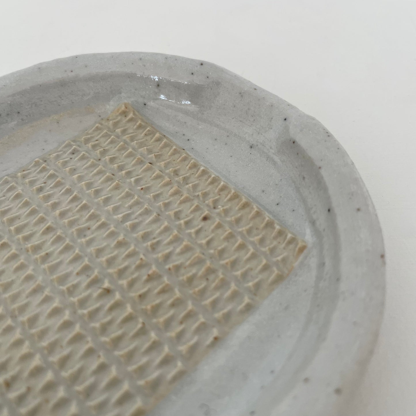 neutral grey and cream gohonte handmade ceramic pottery Japanese small round food grater with handle