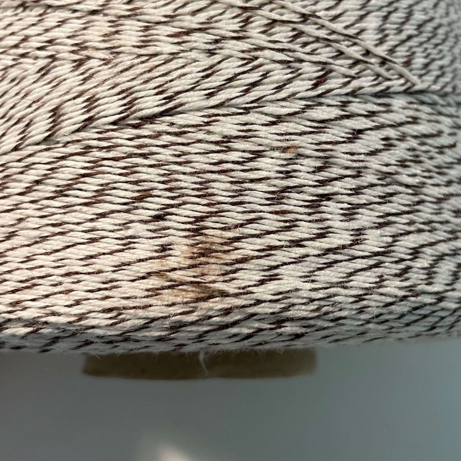 brown and white striped bakers twine two pound cone closeup of stain on side of cone