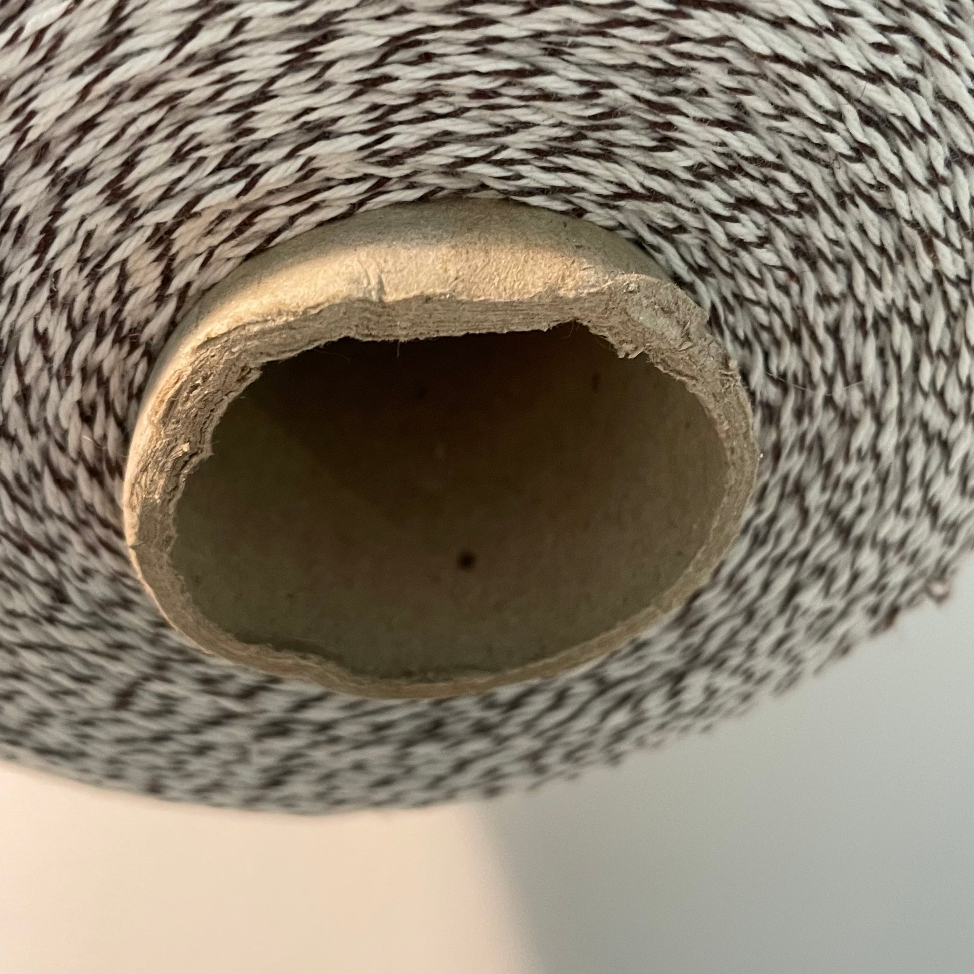 brown and white striped bakers twine two pound cone closeup of cardboard spool which is bent