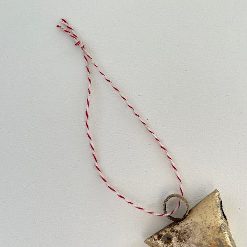 ornaments made out of trapezoid shaped tin bells with brass finish and metal striker and red and white striped twine