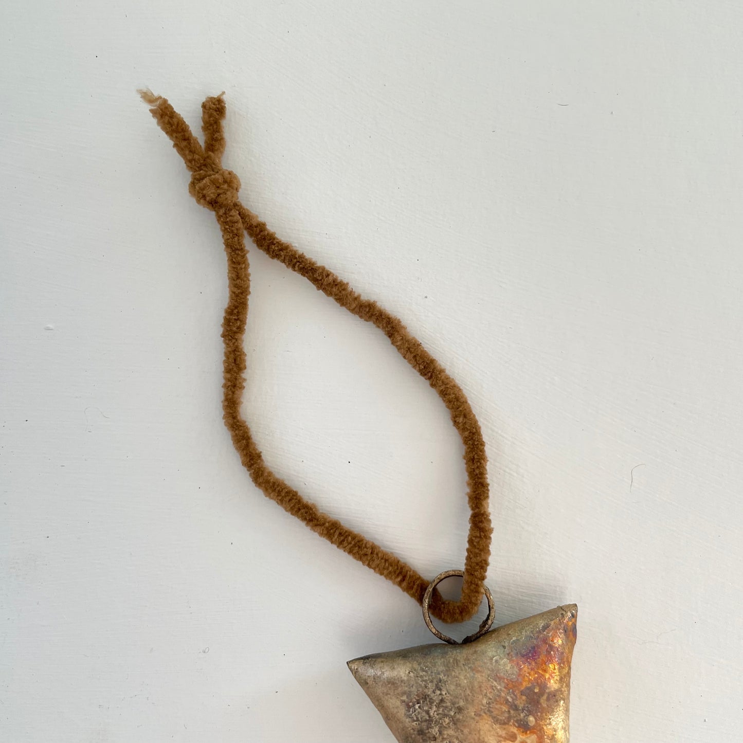 ornaments made out of trapezoid shaped tin bells with brass finish and metal striker and cognac brown cord