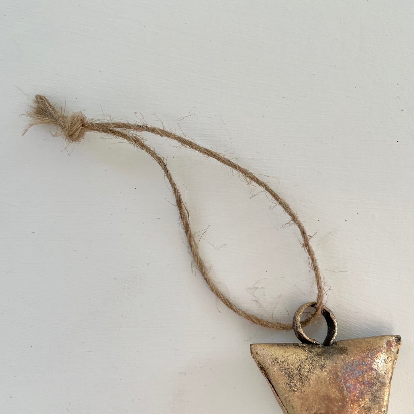 ornaments made out of trapezoid shaped tin bells with brass finish and metal striker and jute cord
