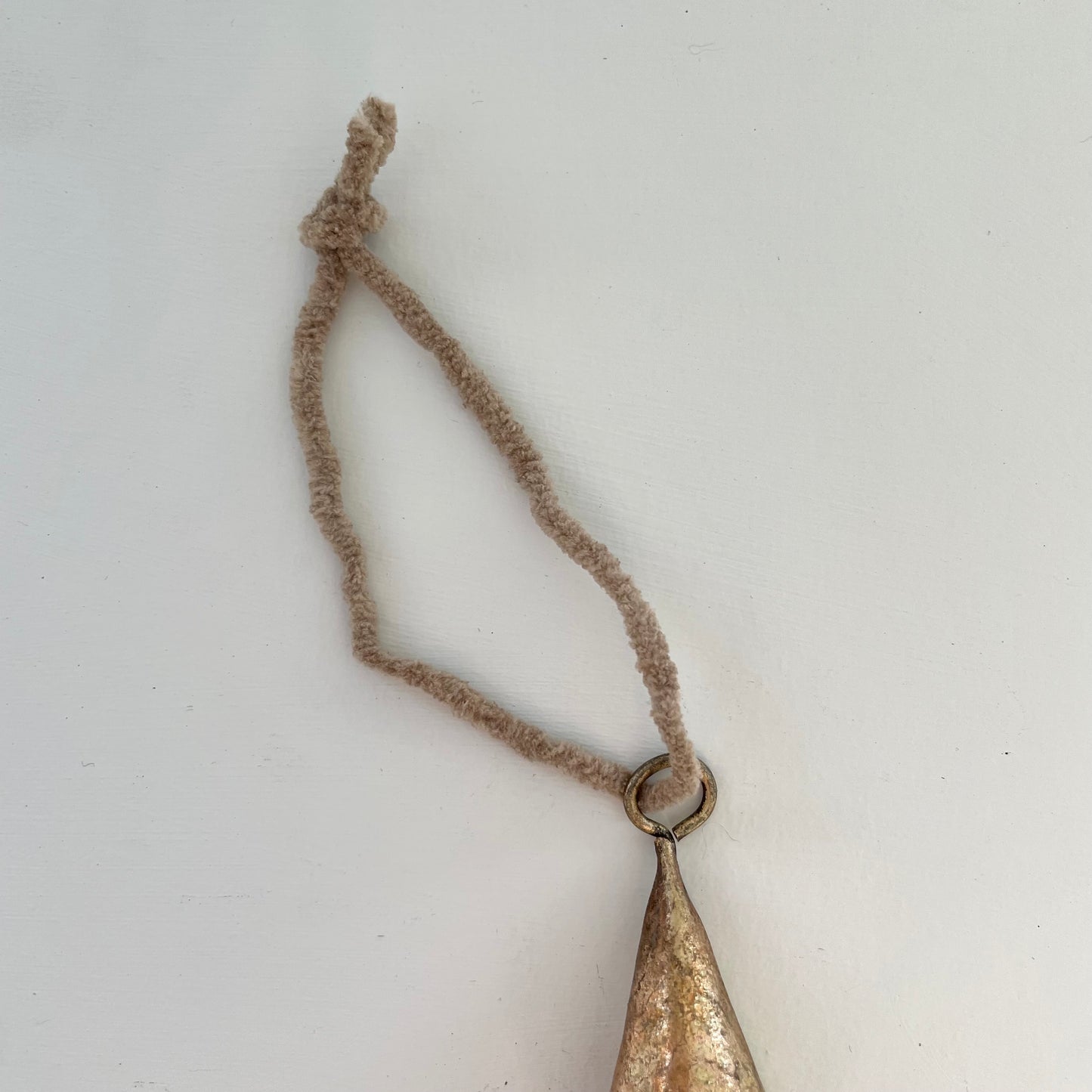 tiny 2 inch cone shaped tin bells with brass finish Christmas holiday ornaments on tan suede cord
