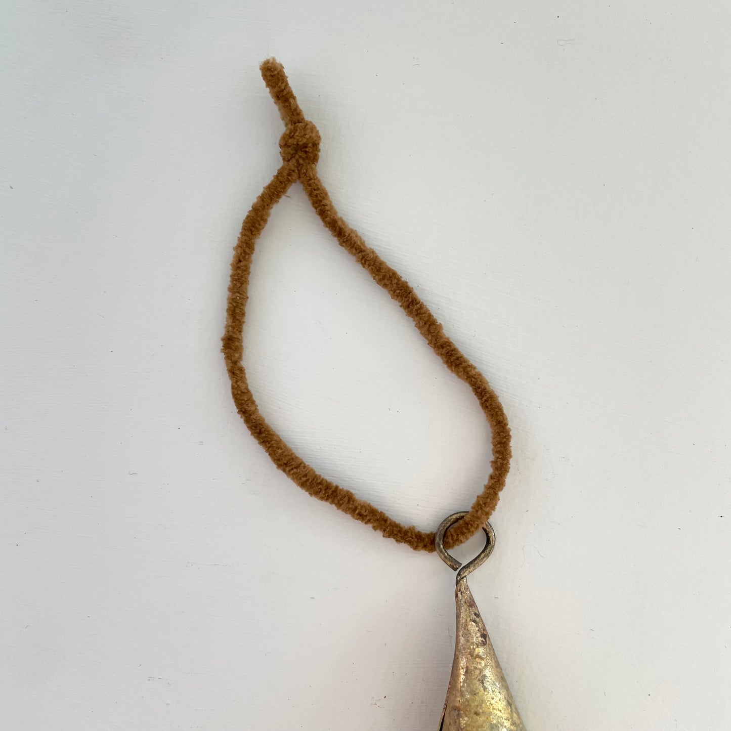 tiny 2 inch cone shaped tin bells with brass finish Christmas holiday ornaments on cognac brown suede cord