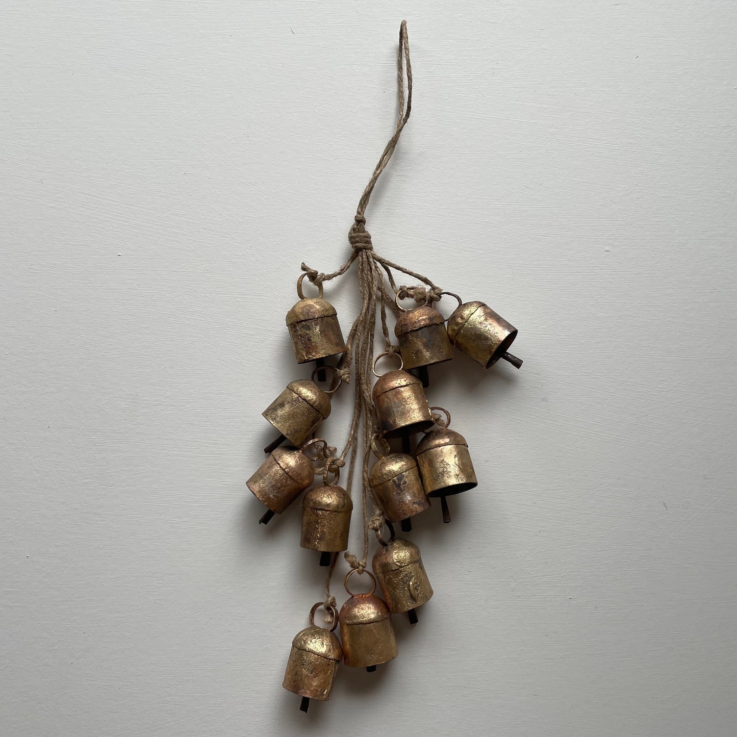 hanging rustic bell garland with 12 cow bells on jute for holiday or garden