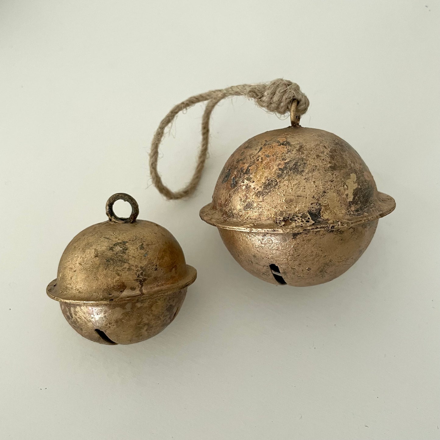 two sizes of rustic sleigh bells with brass finish made in India