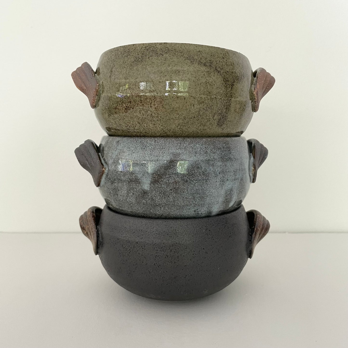 olive green, blue, and black moody handmade soup bowls with handle