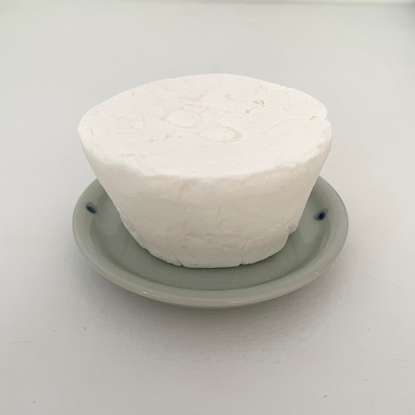 blue round ceramic handmade Japanese dish with etched lines and dots to use for a kitchen eco dish block