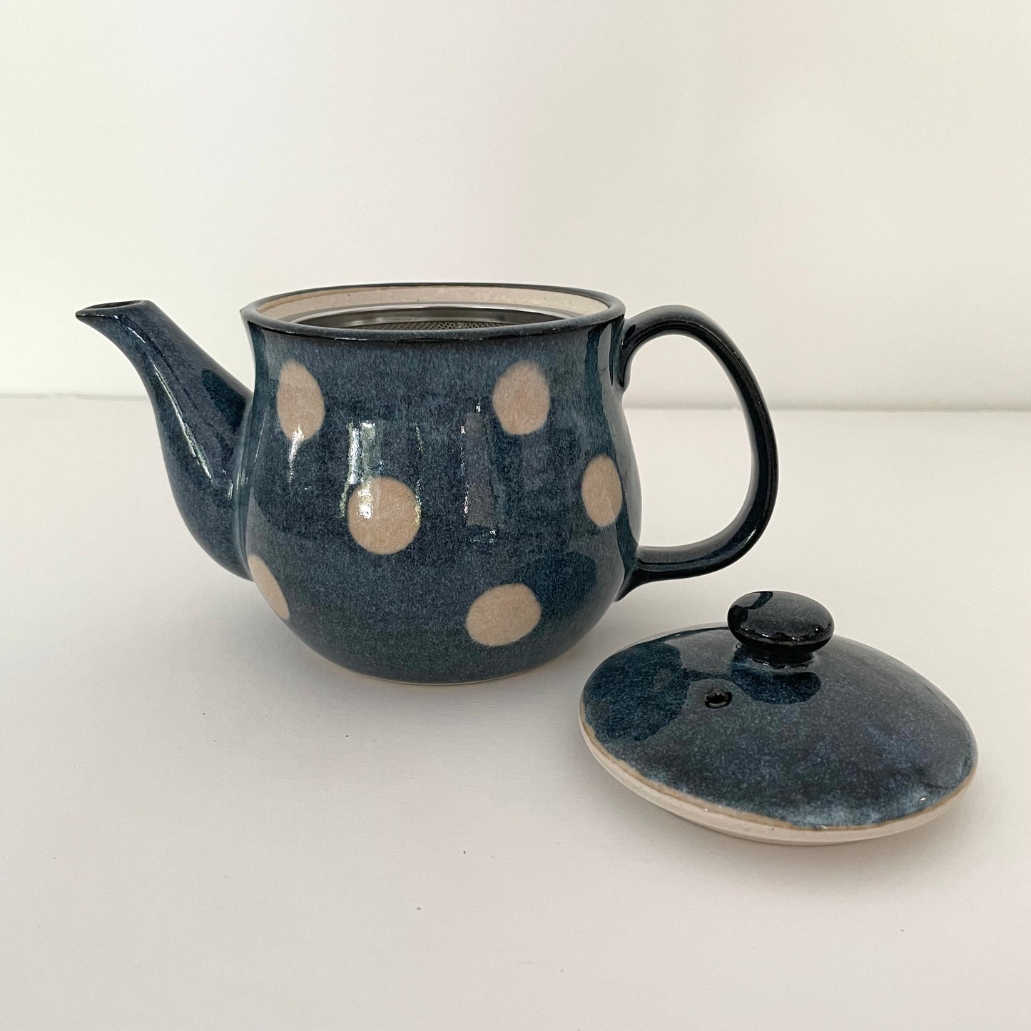 whimsical blue and white polka dot ceramic Japanese handmade teapot with metal strainer