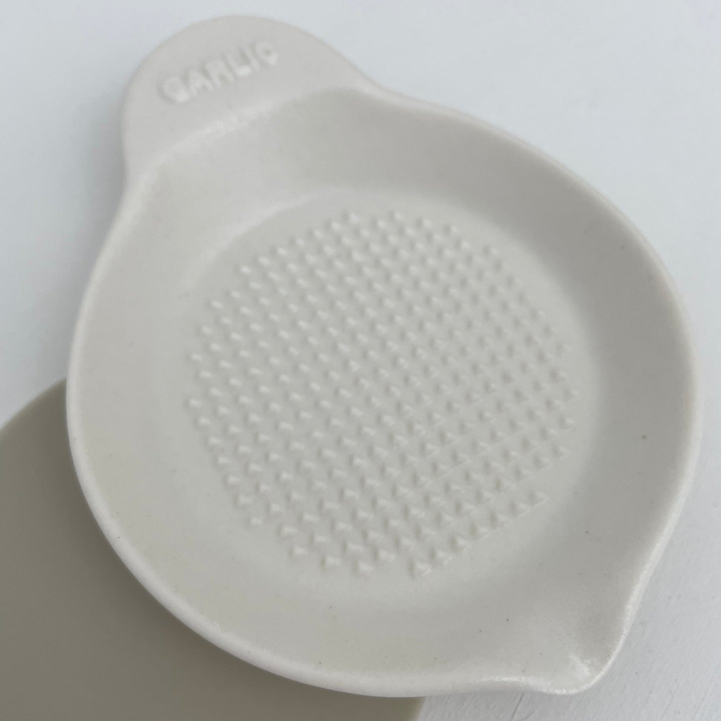 stack of handmade Japanese white ceramic garlic grater