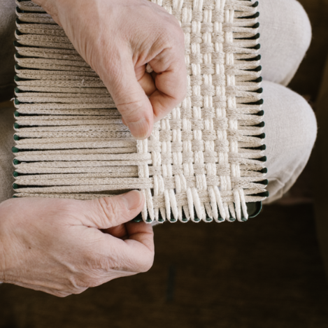 handmade 100 percent cotton geometric woven potholder or trivet on the loom for a farmhouse kitchen