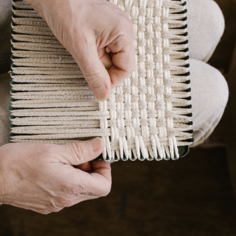 handmade 100 percent cotton geometric woven potholder or trivet on the loom for a farmhouse kitchen