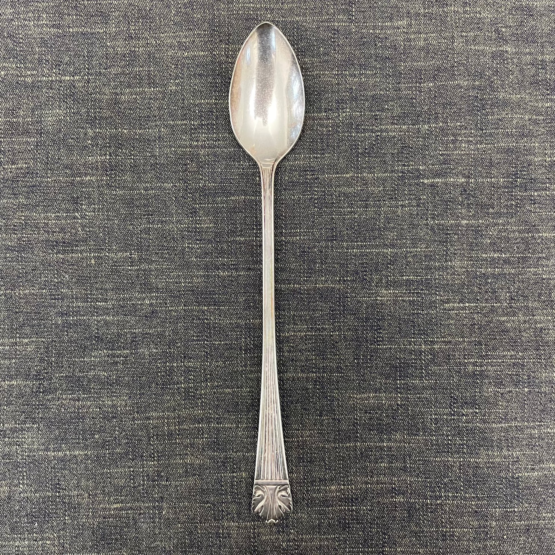 antique silver long handled teaspoon for serving jam or prop photography