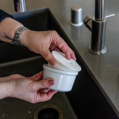 eco and sustainable solid dish soap refill for a farmhouse kitchen in a white porcelain bowl