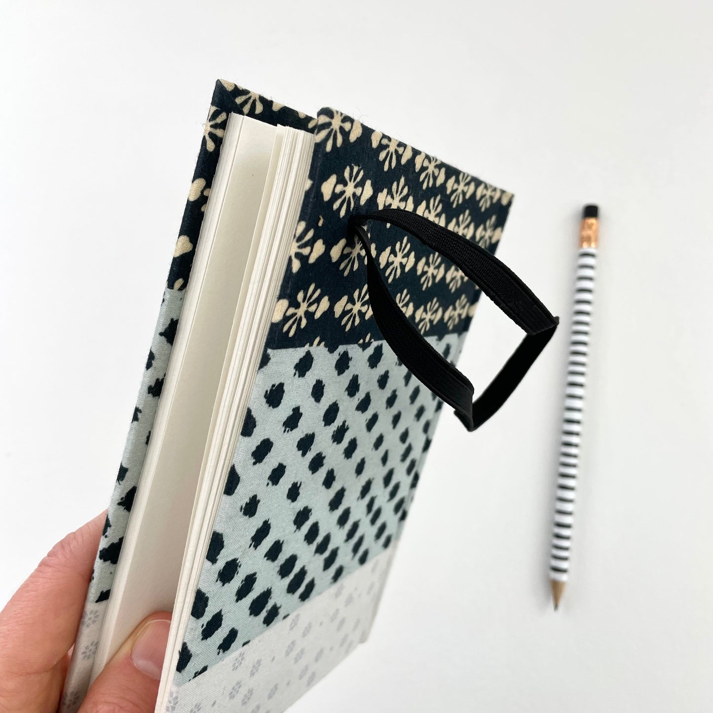 neutral black, cream, and blue fabric covered handmade unlined notebook journal