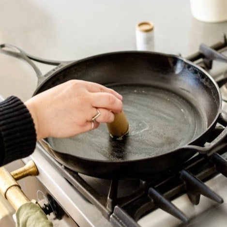 natural cast iron solid seasoning balm made from organic beeswax, safflower oil, grapeseed oil, flaxseed oil, and vitamin E in a biodegradable container