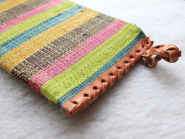 bright green, pink, blue, and yellow striped raffia woven zippered clutch with leather trim bohemian