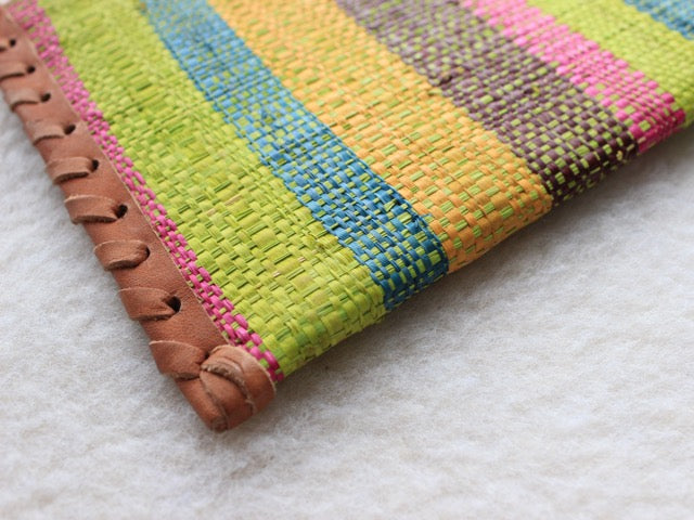 bright green, pink, blue, and yellow striped raffia woven zippered clutch with leather trim bohemian