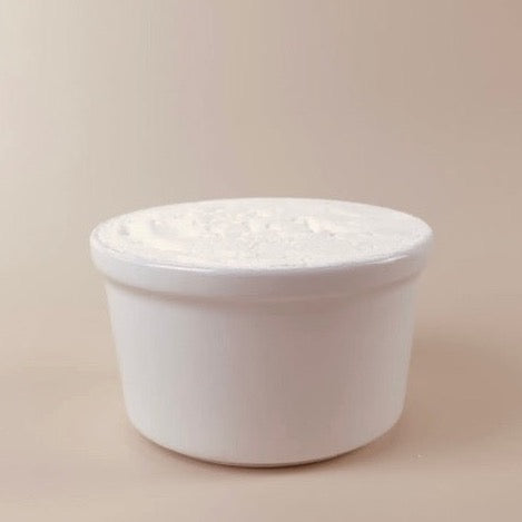 eco and sustainable solid dish soap for a farmhouse kitchen in a white porcelain bowl