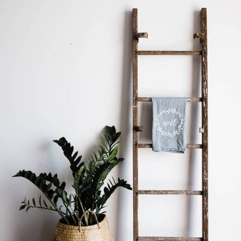 set of 2 grey 100 percent organic cotton hand printed Christmas holiday dishtowels for a farmhouse kitchen with noel printed on them in white ink