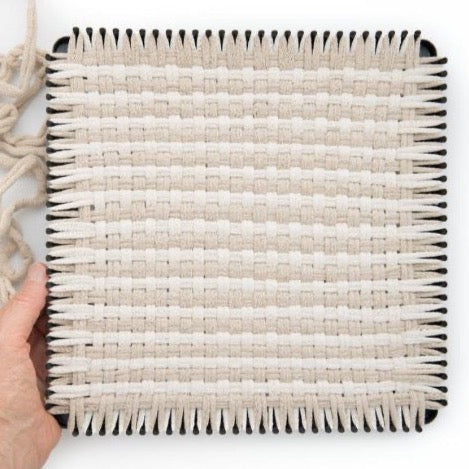 handmade 100 percent cotton bobble woven potholder or trivet on the loom for a farmhouse kitchen
