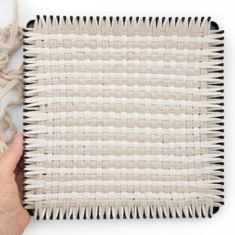 handmade 100 percent cotton geometric woven potholder or trivet on the loom for a farmhouse kitchen