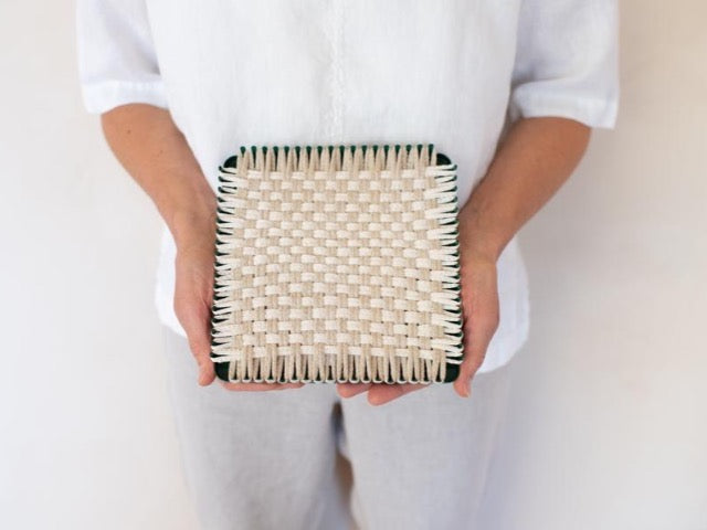handmade 100 percent cotton geometric woven potholder or trivet on the loom for a farmhouse kitchen
