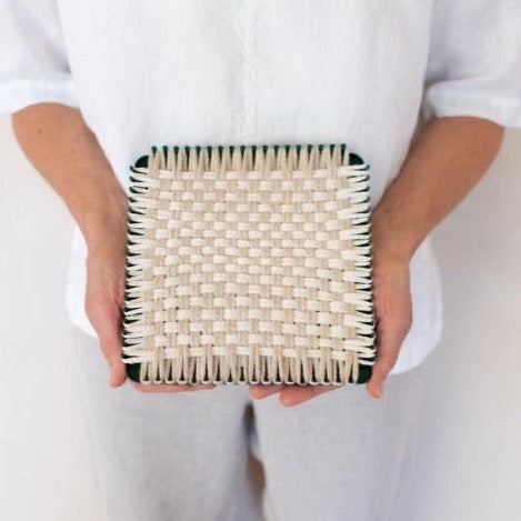 handmade 100 percent cotton geometric woven potholder or trivet on the loom for a farmhouse kitchen