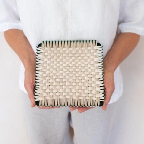 handmade 100 percent cotton geometric woven potholder or trivet on the loom for a farmhouse kitchen