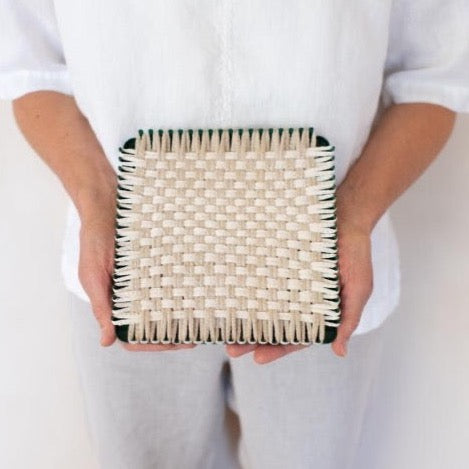 handmade 100 percent cotton geometric woven potholder or trivet on the loom for a farmhouse kitchen