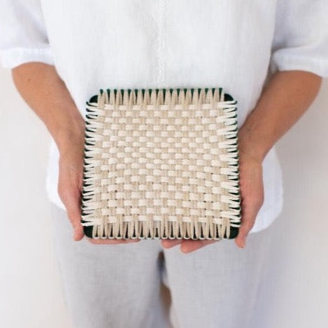 handmade 100 percent cotton bobble woven potholder or trivet on the loom for a farmhouse kitchen
