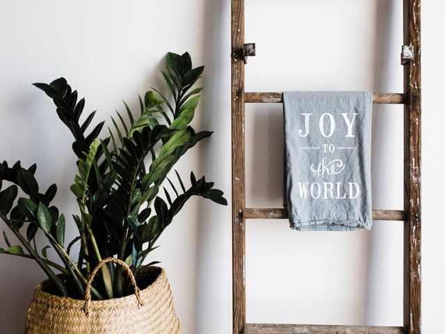 set of 2 white 100 percent organic cotton hand printed Christmas holiday dishtowels for a farmhouse kitchen with joy to the world printed on them in black ink