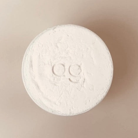 eco and sustainable solid dish soap for a farmhouse kitchen in a white porcelain bowl