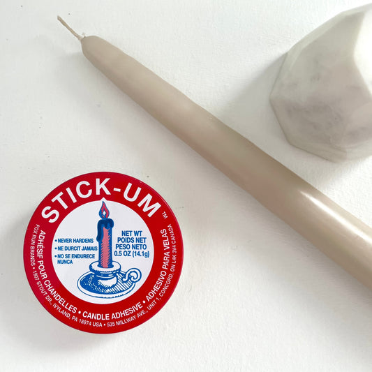 stick-um candle wax adhesive to keep tapers upright in the stand