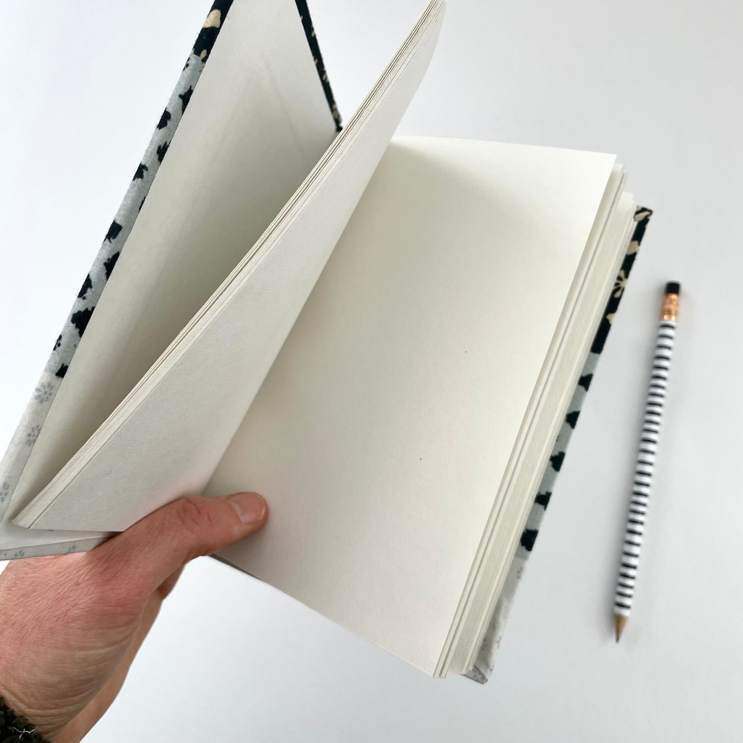 neutral black, cream, and blue fabric covered handmade unlined notebook journal