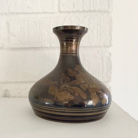 vintage brass vase with an etched floral and foliage pattern