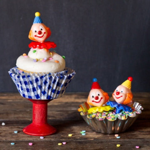 retro clown cupcake toppers for a birthday party in blue and white gingham cupcake liners