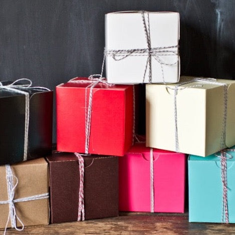 4x4 square bakery boxes in a stack wrapped with striped bakers twine 