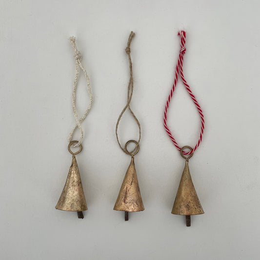 2 1/4" rustic cone tin bell with brass finish ornament on jute, red and white cotton yarn, and cream and gold sweater knit