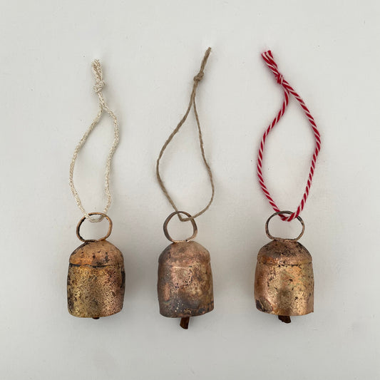 2 1/4" rustic rounded top tin bell with brass finish ornament on jute, red and white cotton twine, and cream and gold sweater knit