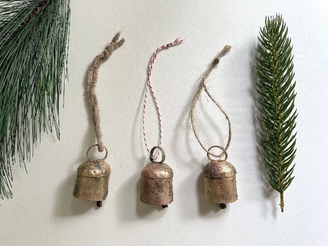 tiny rounded top tin bells with brass finish Christmas holiday ornaments on jute, suede, and bakers twine