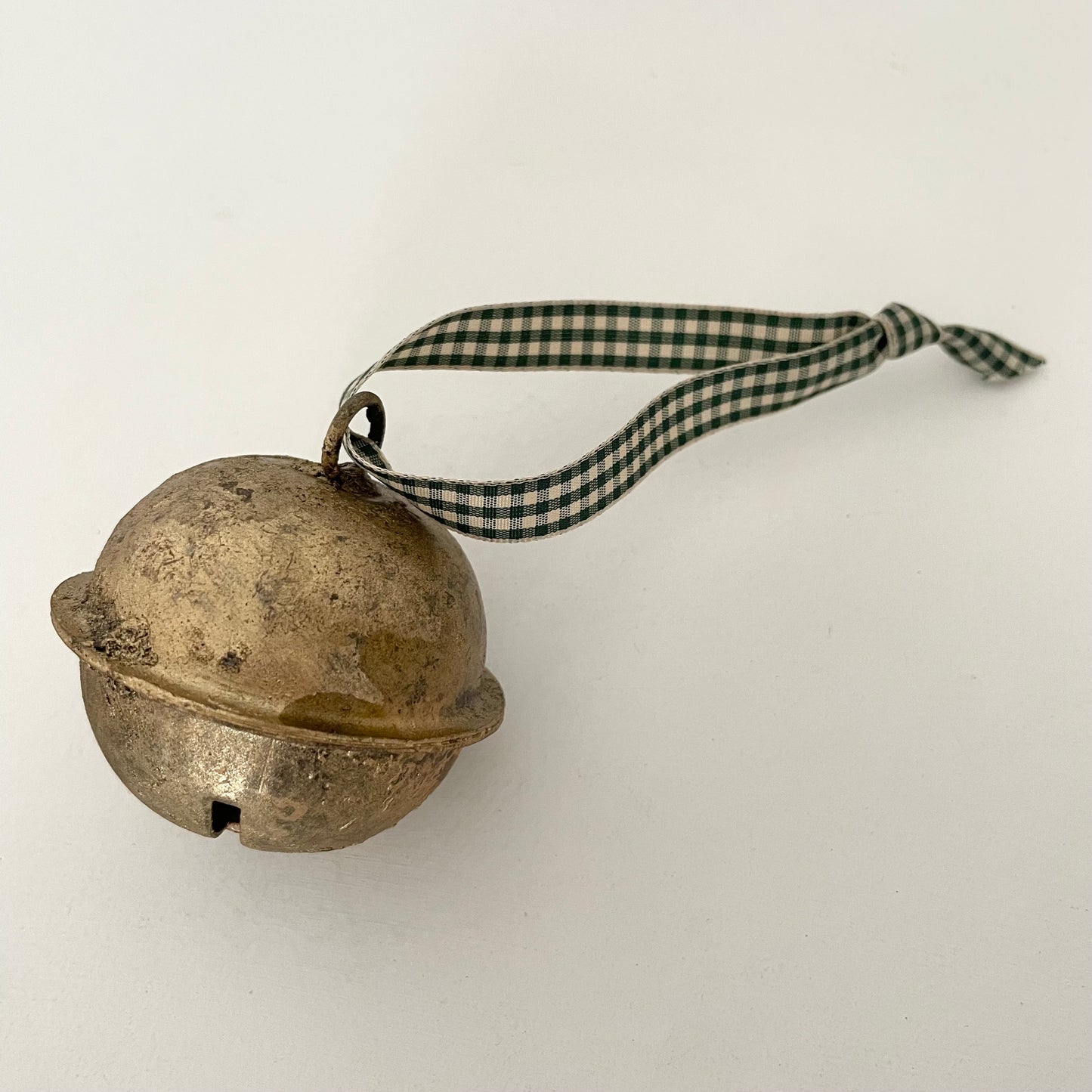 2 1/2" cross-cut brass sleigh bell made in India strung on check gingham taffeta ribbon made in Japan for door hanger