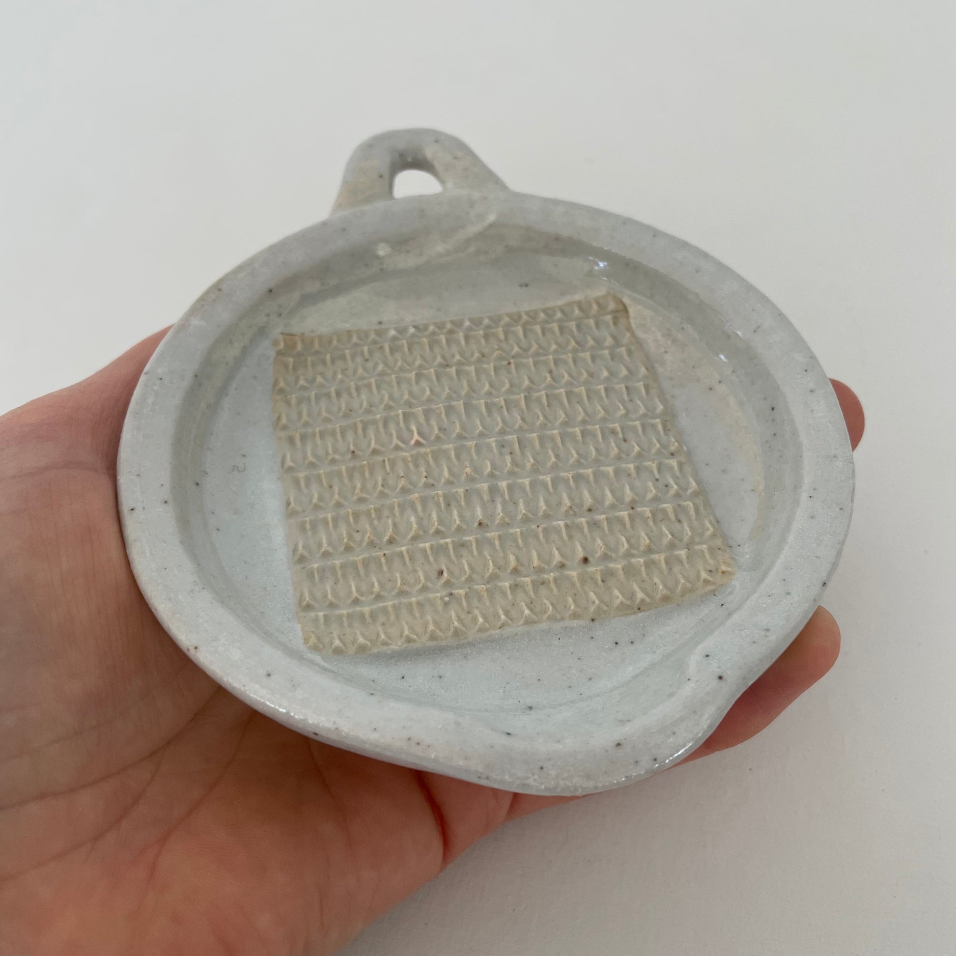 neutral grey and cream gohonte handmade ceramic pottery Japanese small round food grater with handle