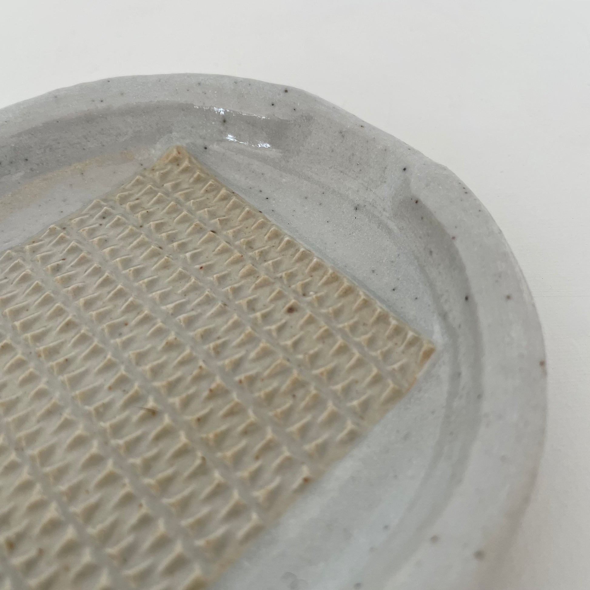 neutral grey and cream gohonte handmade ceramic pottery Japanese small round food grater with handle