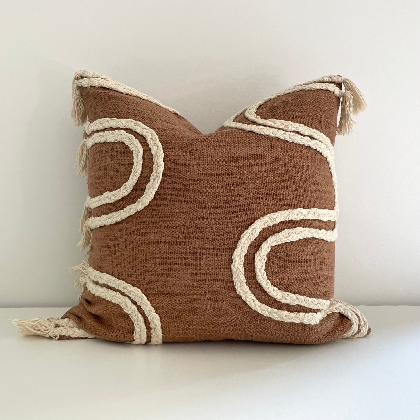 neutral rust and cream woven 18 inch square boho pillow cover with braids and tassels