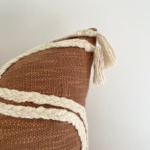 neutral rust and cream woven 18 inch square boho pillow cover with braids and tassels