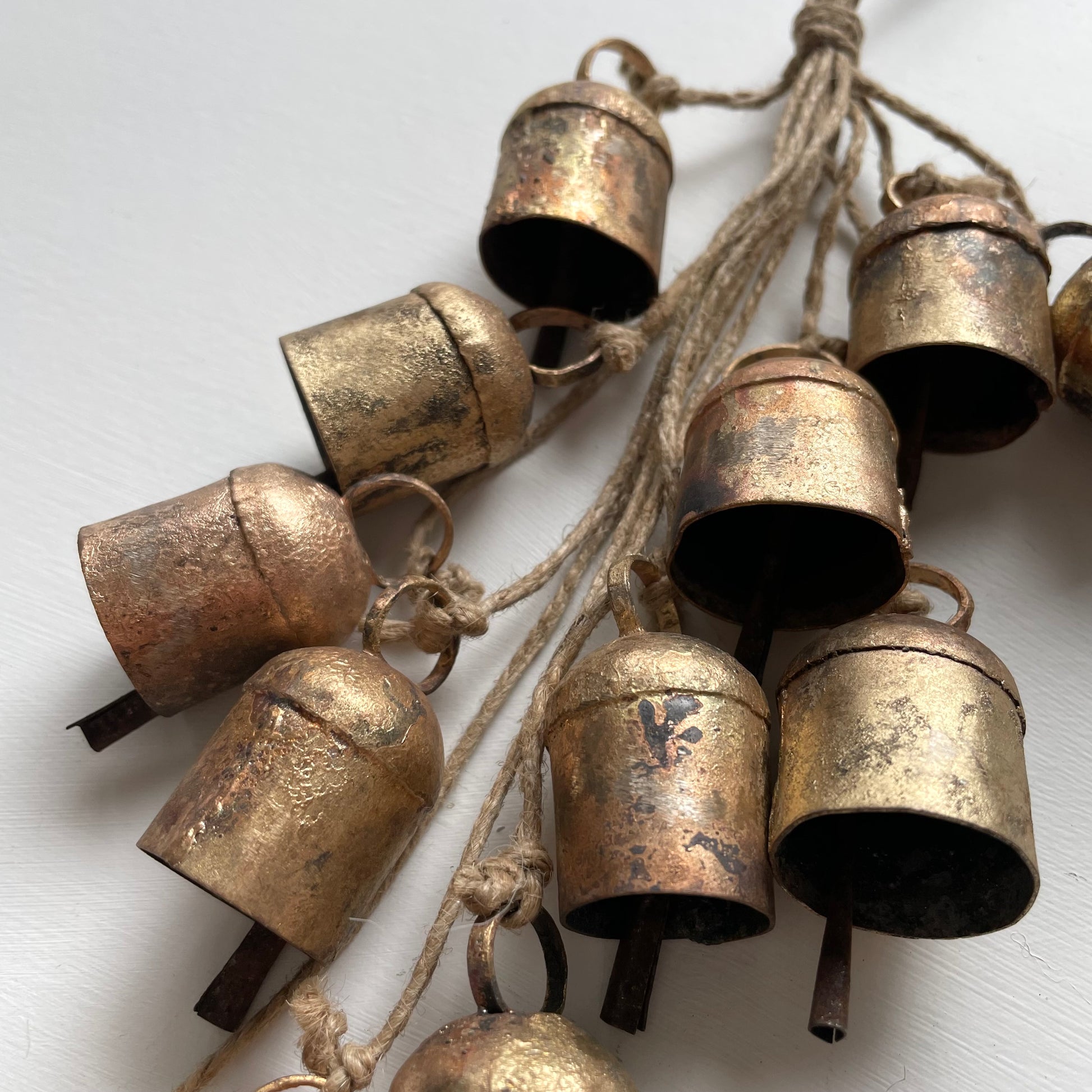 hanging rustic bell garland with 12 cow bells on jute for holiday or garden